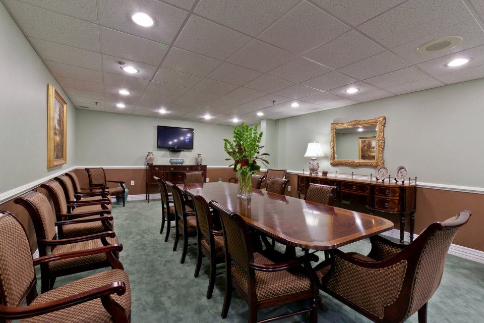 Meeting room with a long wooden table and chairs