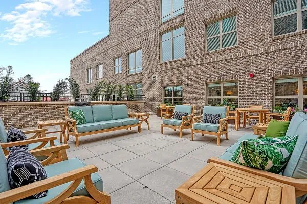 Outdoor seating area with greenery and natural light