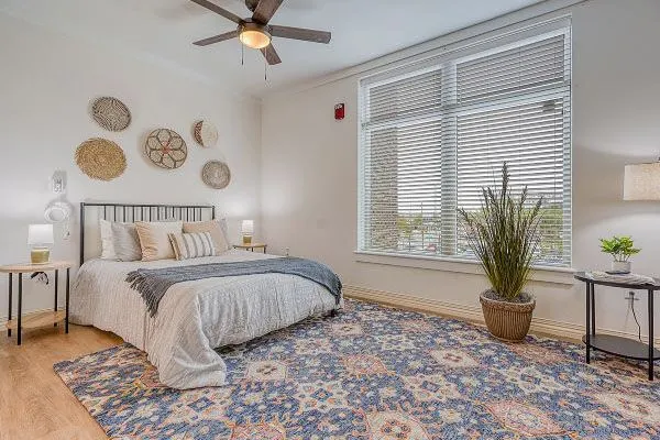 Bright resident room with bed and decor.