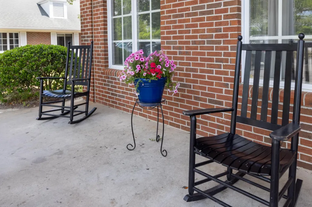 Rocking chairs on a porch with flowers