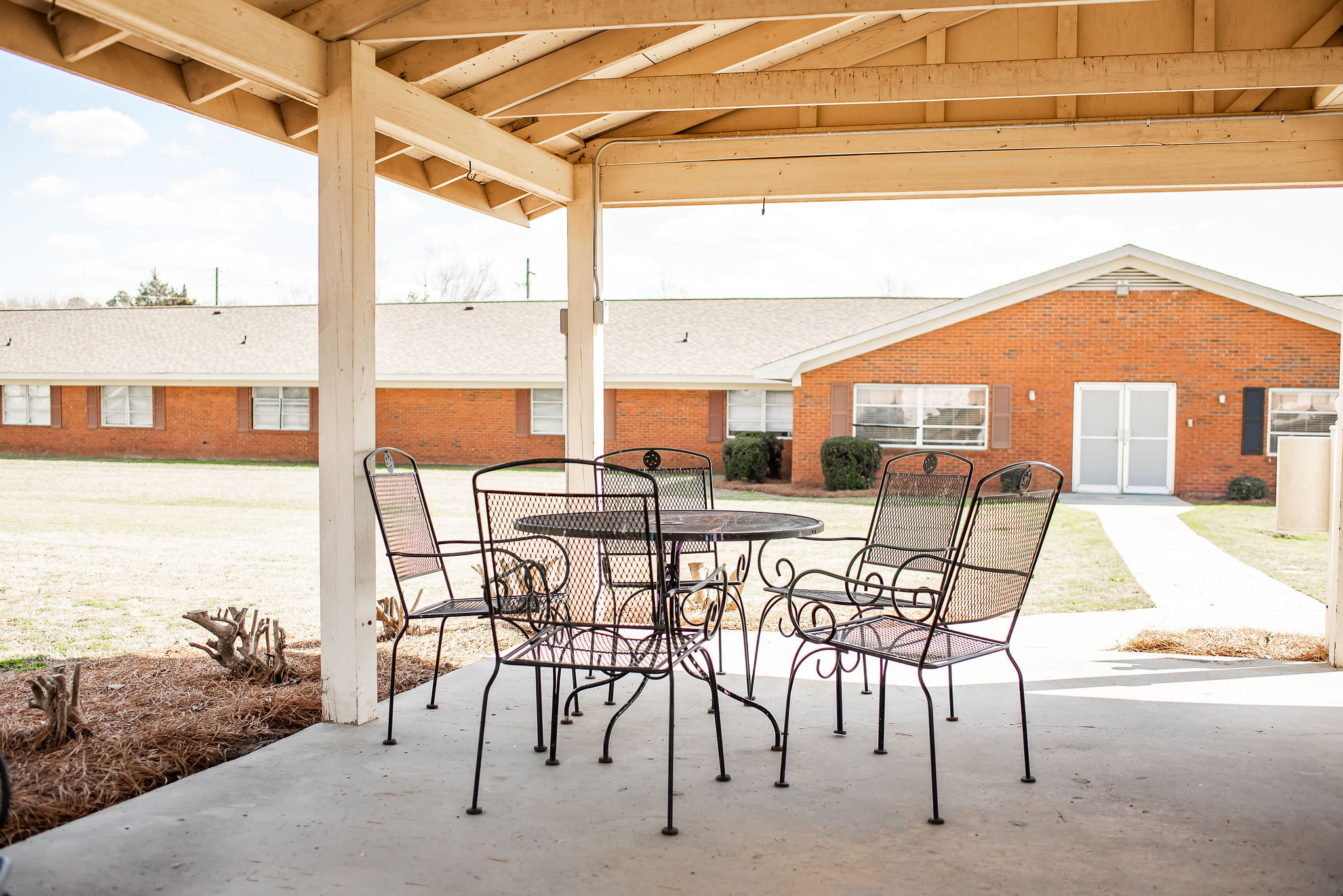 Outdoor seating area with view of the facility building