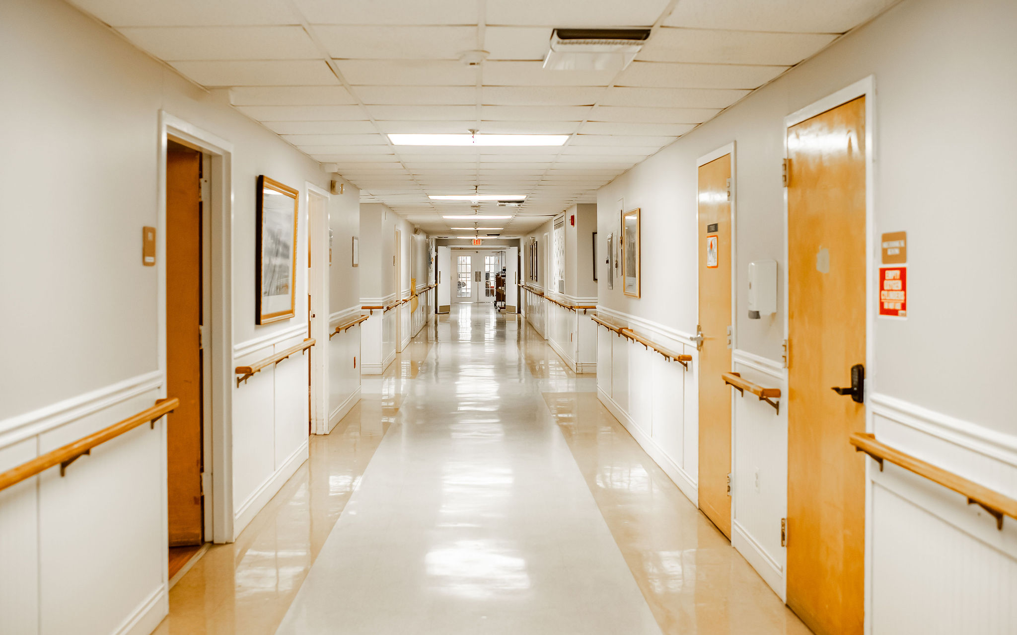 A well-lit corridor in a senior living facility