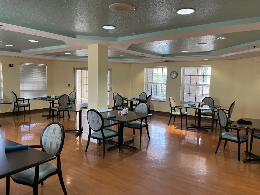 Dining area with tables and chairs in a bright room