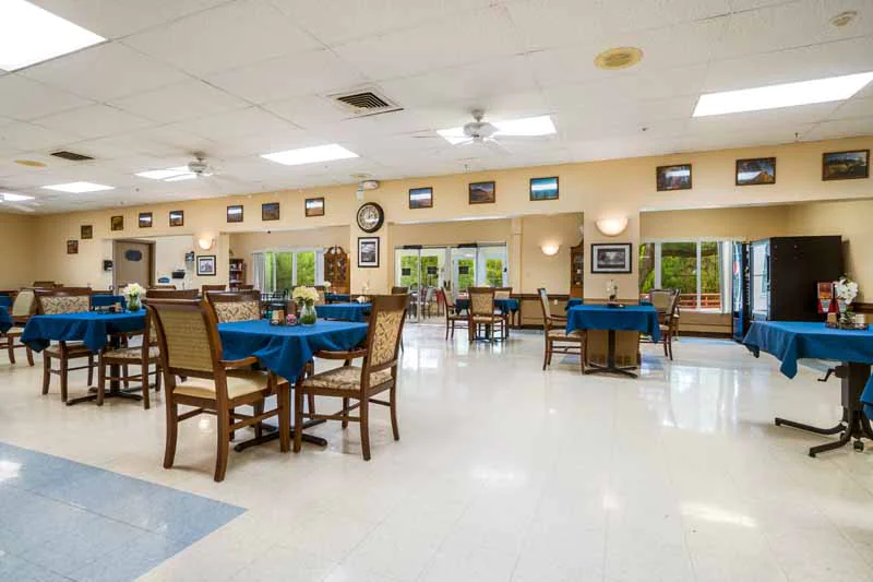 Dining area with tables and chairs in a care facility