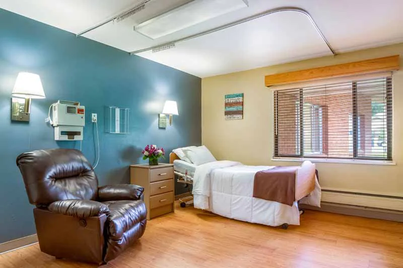 Cozy resident room with a comfortable chair and bed