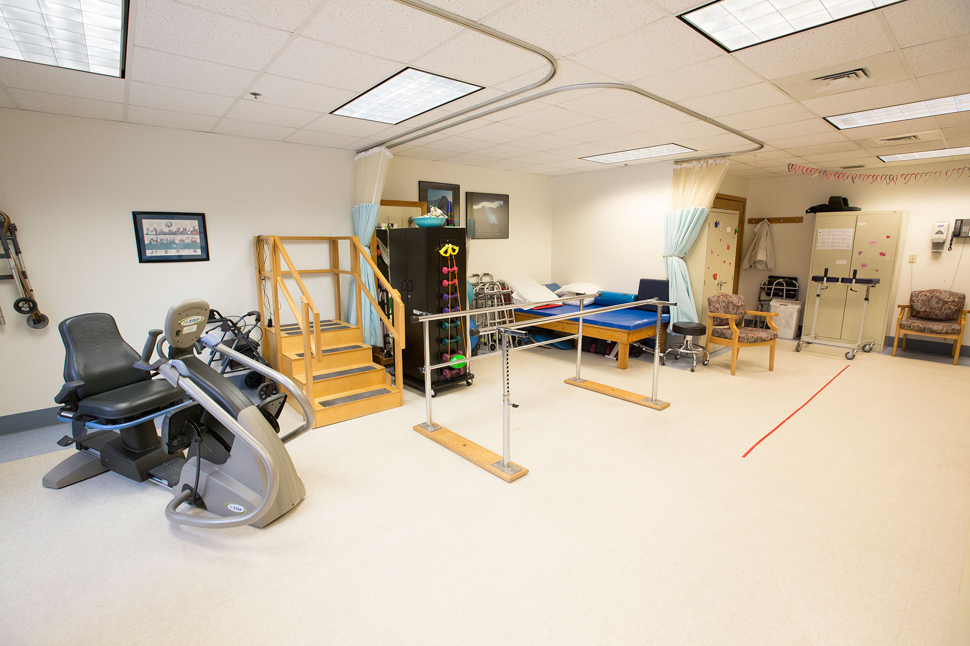 Rehabilitation room with gym equipment and therapy area