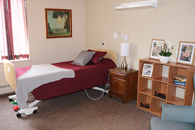 Cozy private resident room with bed and decor