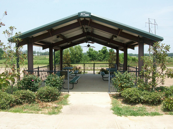 Outdoor pavilion with seating and vegetation