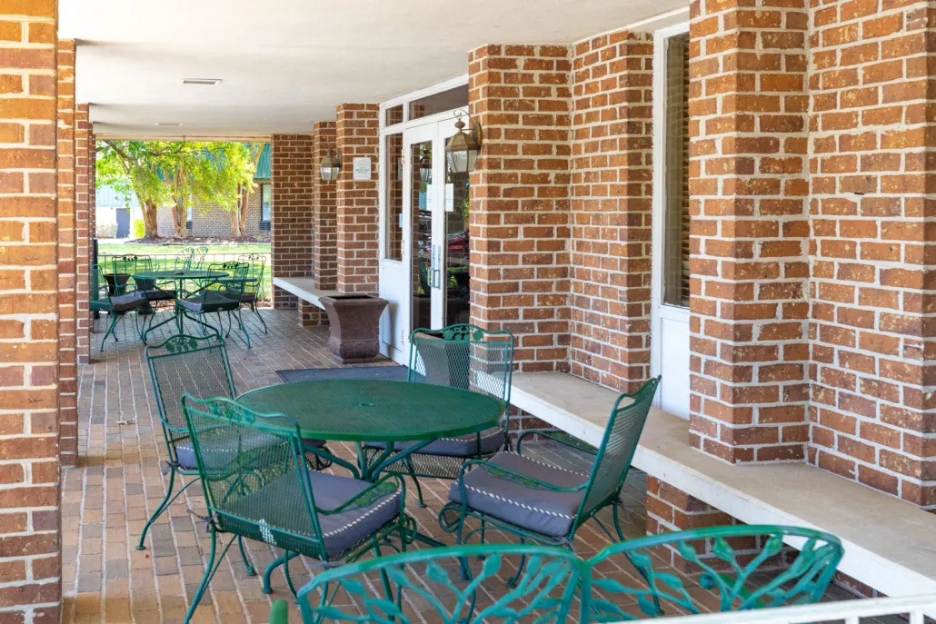 Outdoor seating area with green chairs and tables