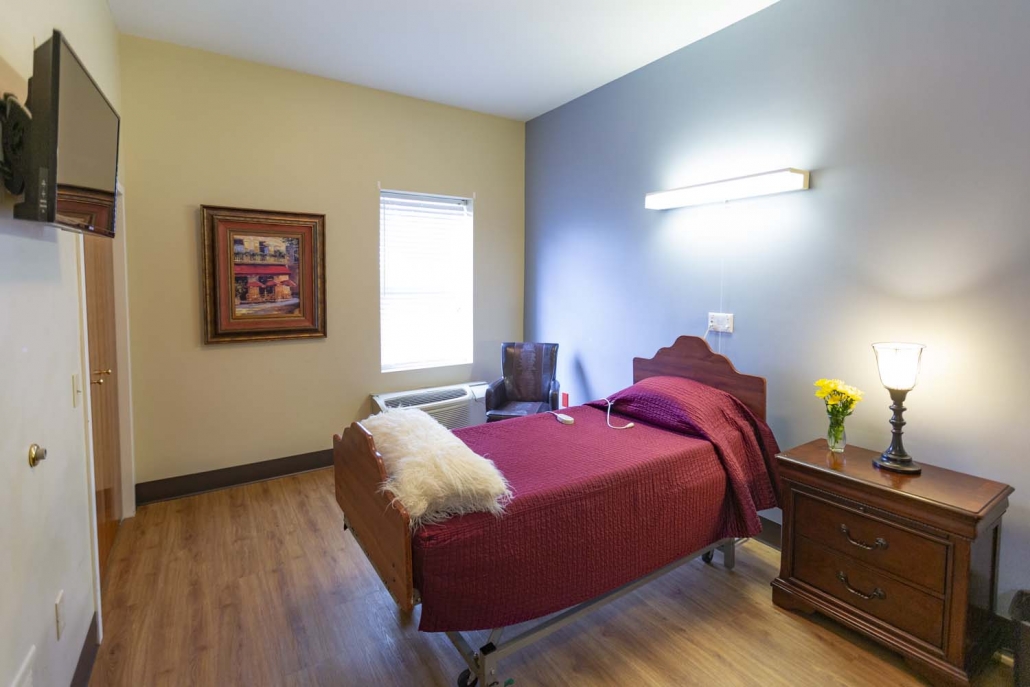 Cozy resident room with a bed and nightstand