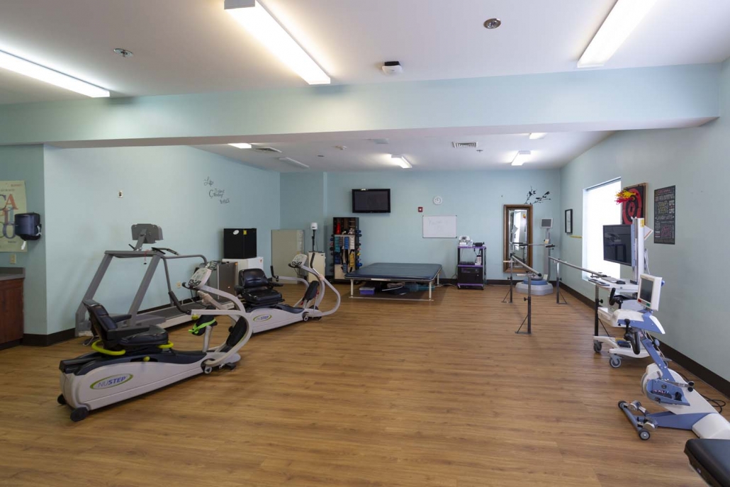 Rehabilitation gym with exercise equipment and therapy space