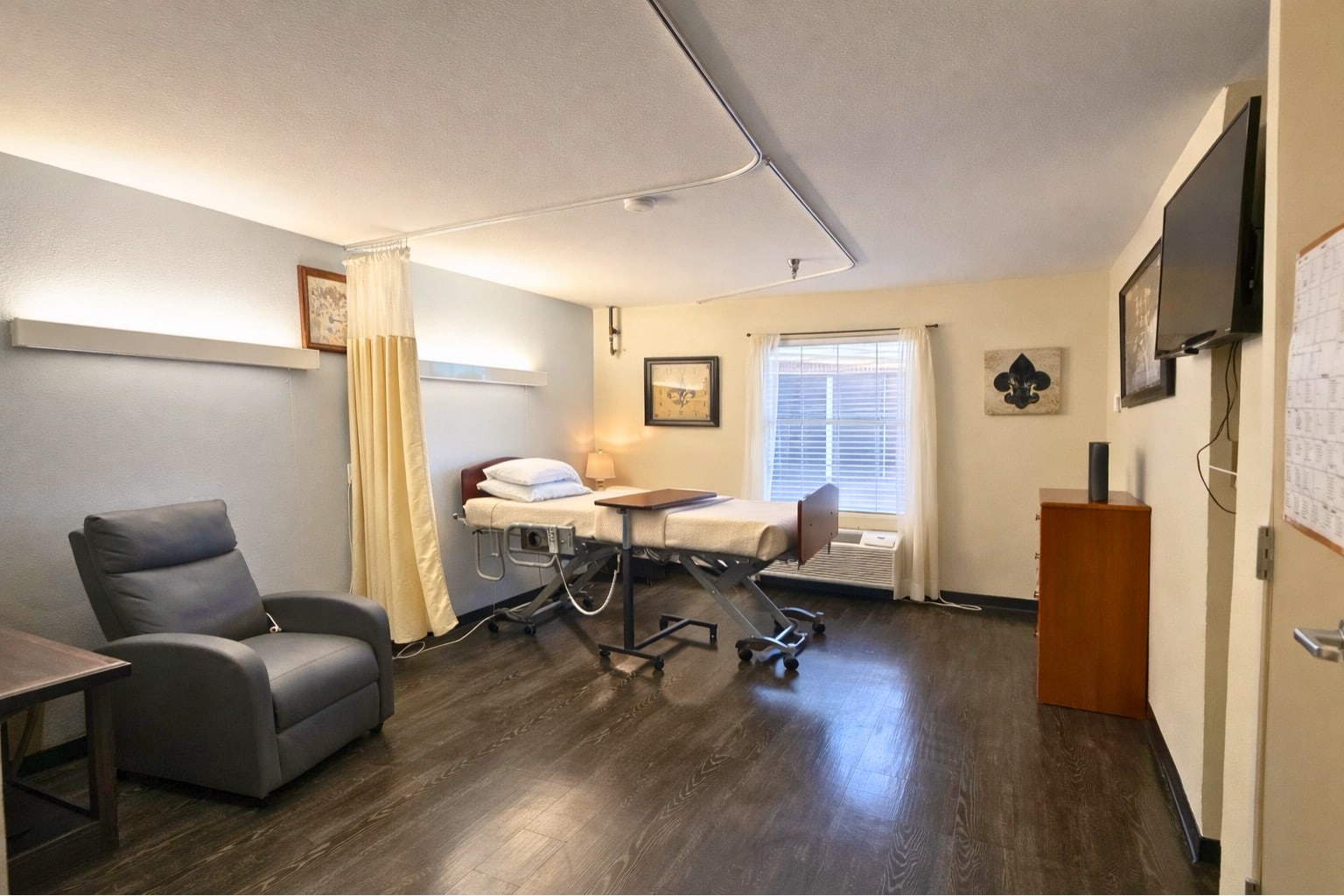 A private resident room with a bed and chair