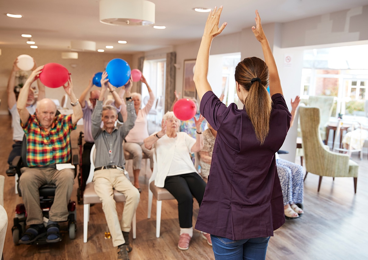Residents participating in a balloon toss activity