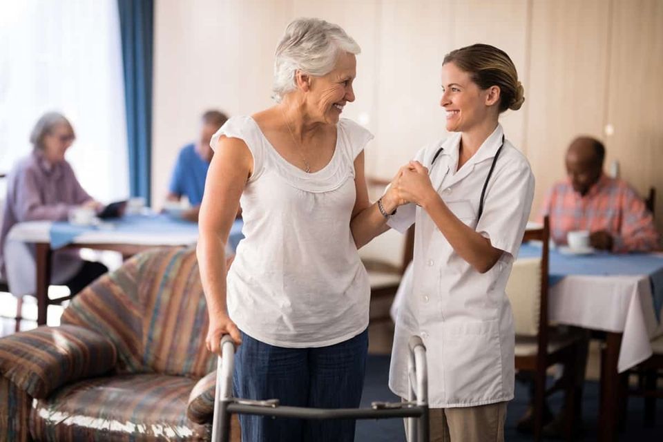 Staff assisting a resident in a common area