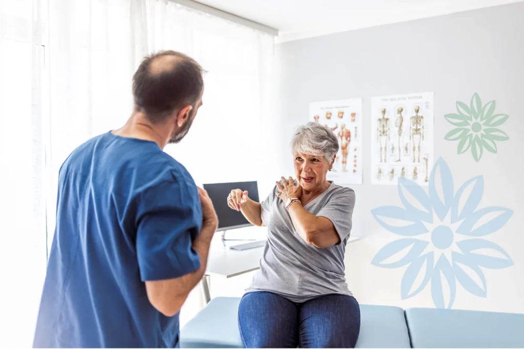 Therapist assisting a senior woman in a rehab setting.