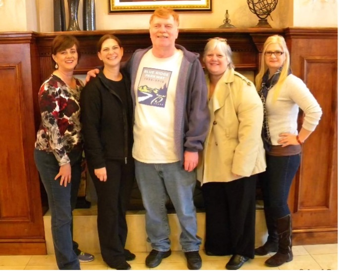 Group of staff and residents pose in the lobby.