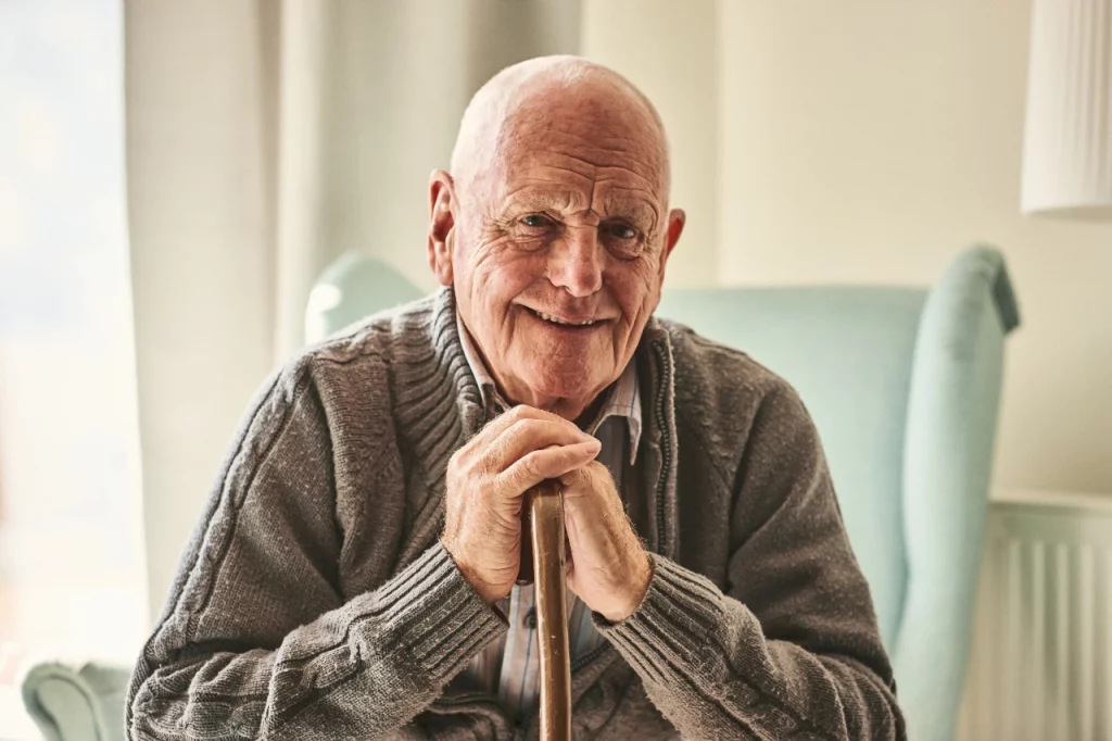 Smiling elderly man sitting in a chair