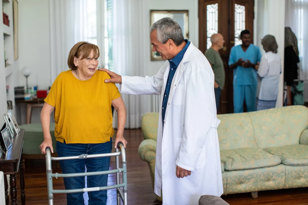 Senior resident engaging with a staff member in a communal area.