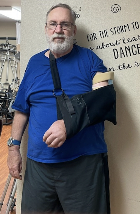 Man with arm in sling in common area