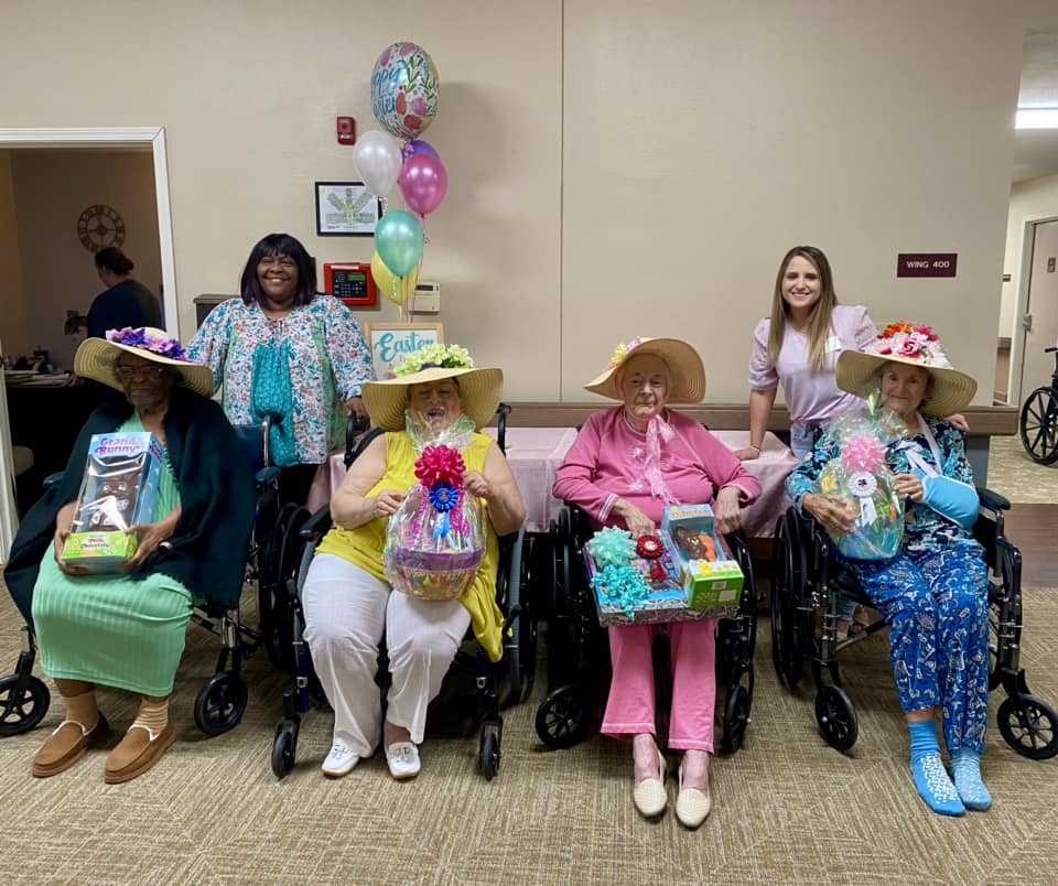 Residents celebrating with gift baskets in a common area