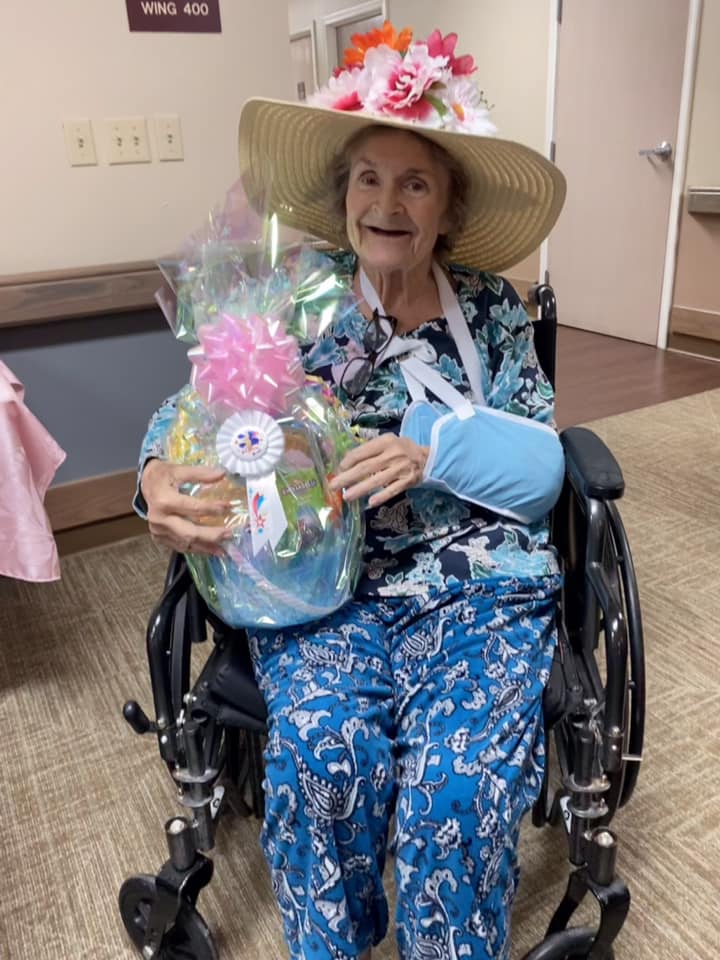 Resident in a wheelchair holding a gift basket