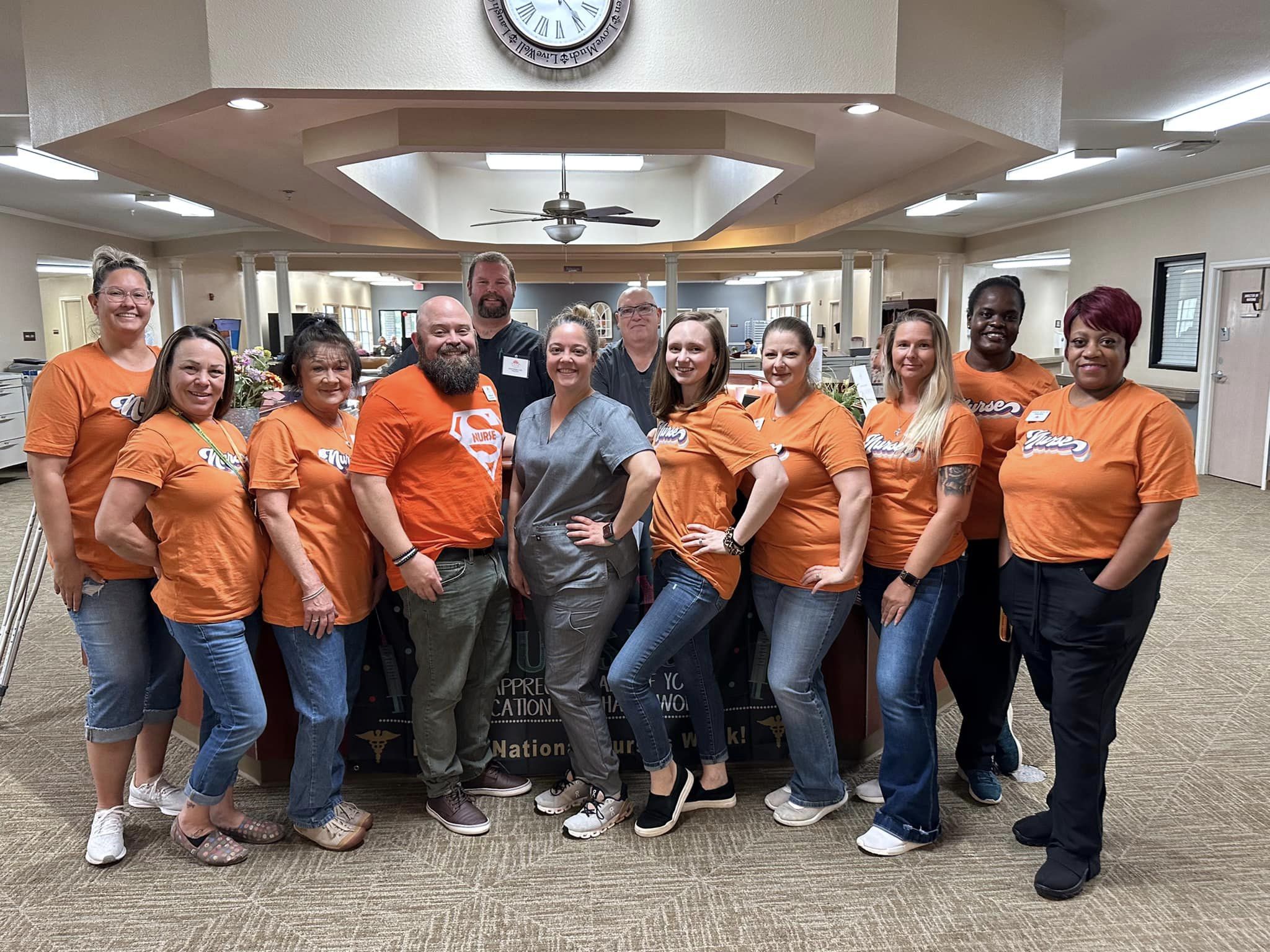 Staff and residents in casual shirts at facility