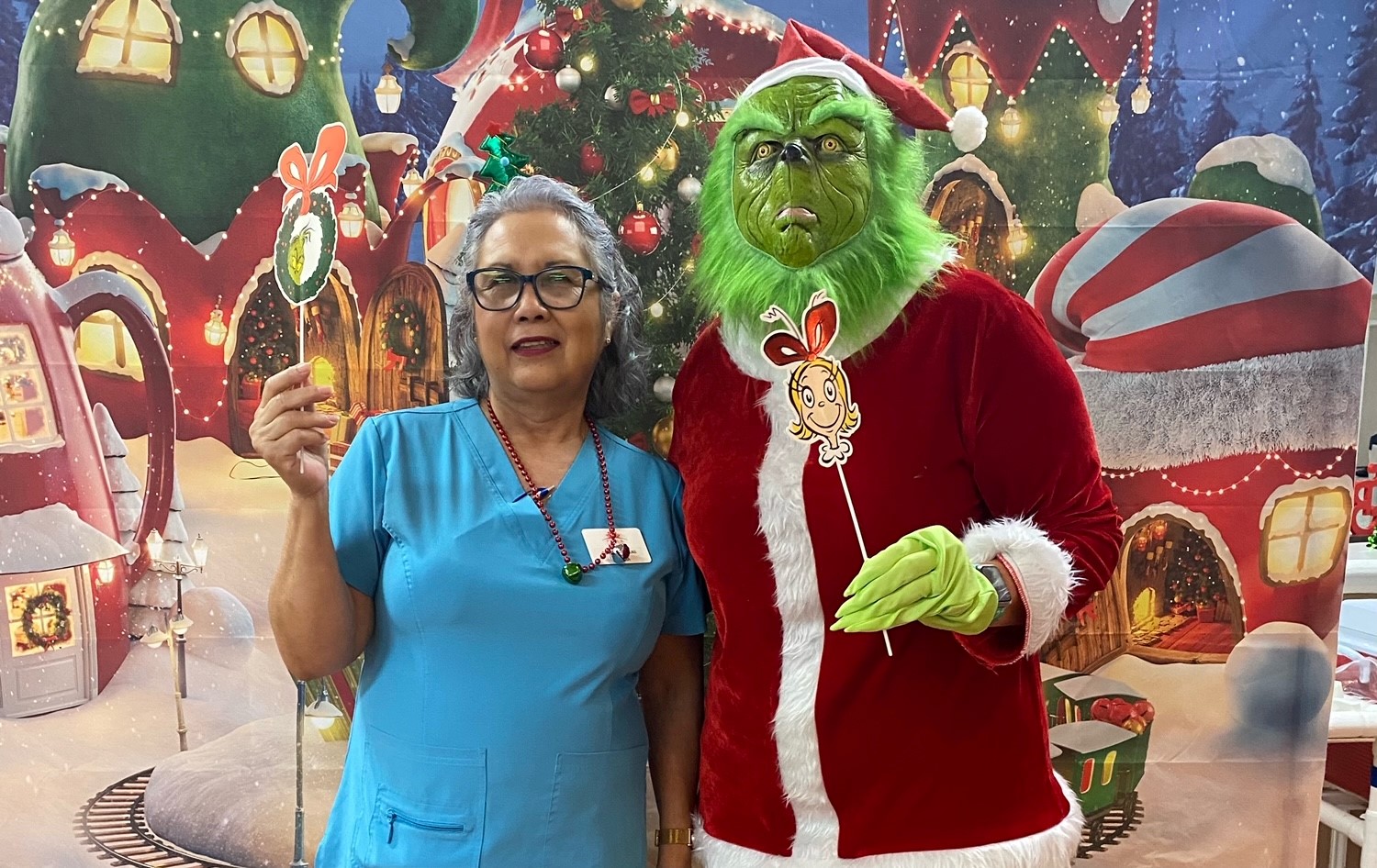 Staff member with a character costume at a festive event.