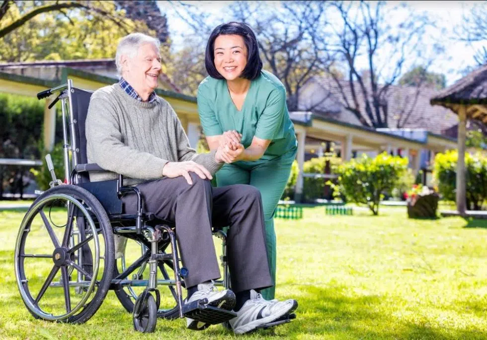Caregiver assisting resident in the garden