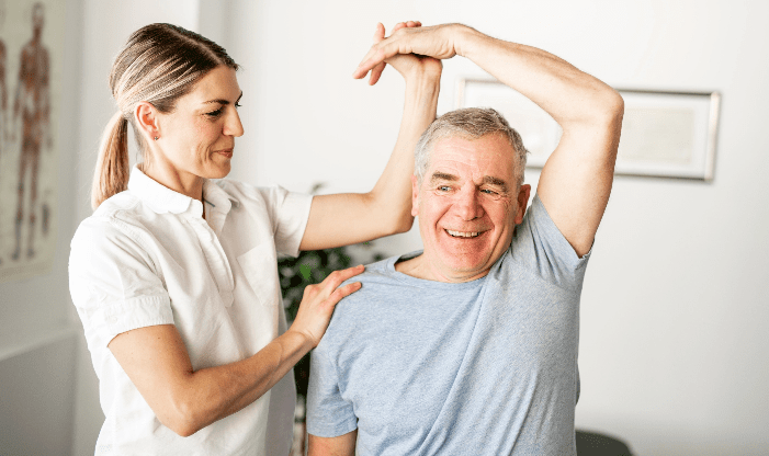 Physical therapy session with a smiling senior man
