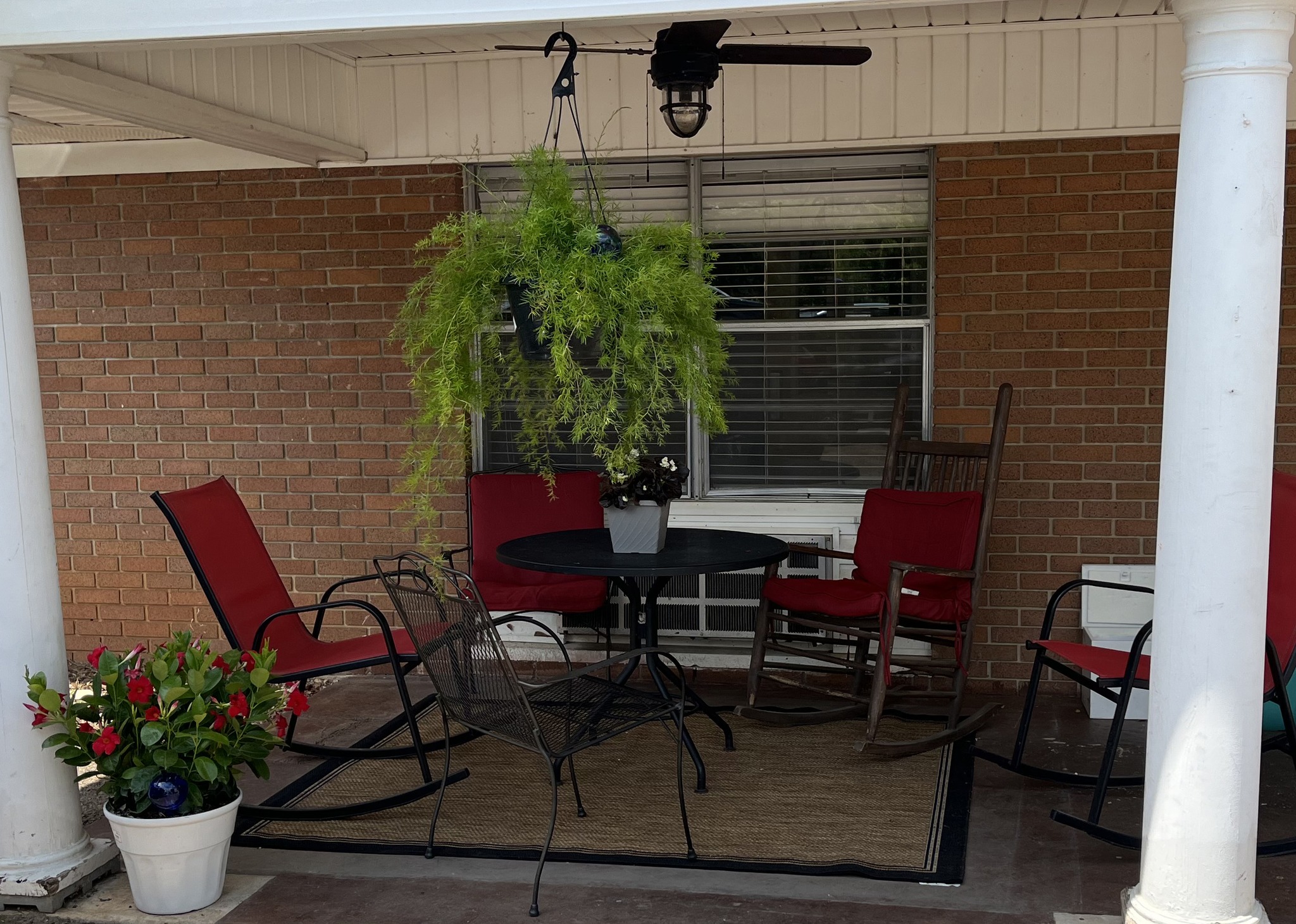 Outdoor seating area with rocking chairs and plants