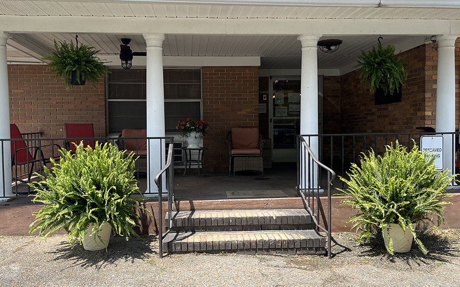 Entrance with greenery and seating area