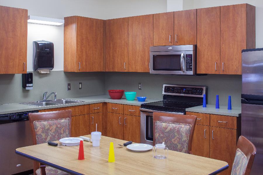 Bright kitchen area with wooden cabinets and countertops