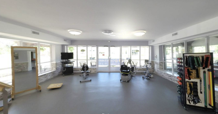 Rehabilitation gym area with exercise equipment