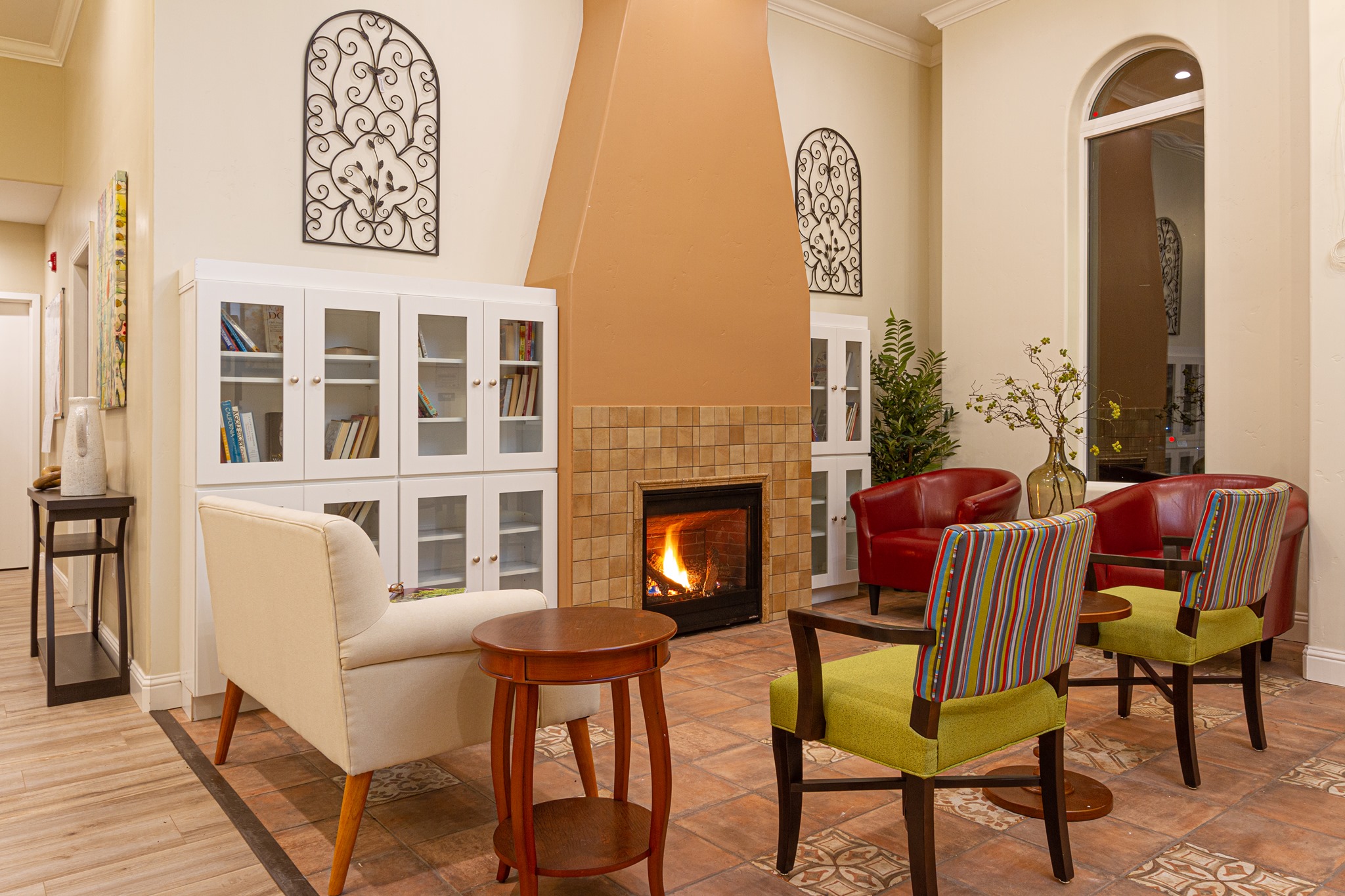 Cozy common area with seating around a fireplace