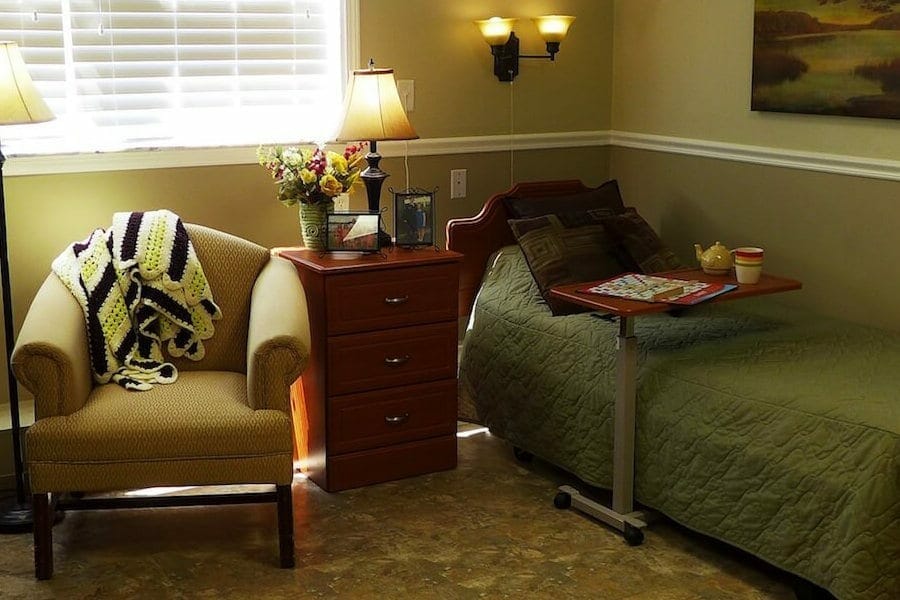 Cozy resident room with bed and armchair