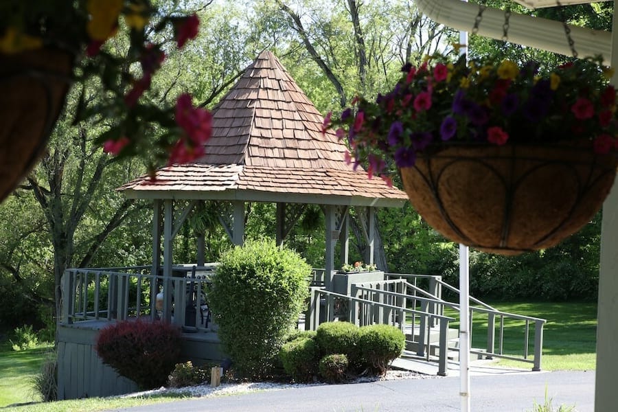 Outdoor gazebo surrounded by flowers in a garden