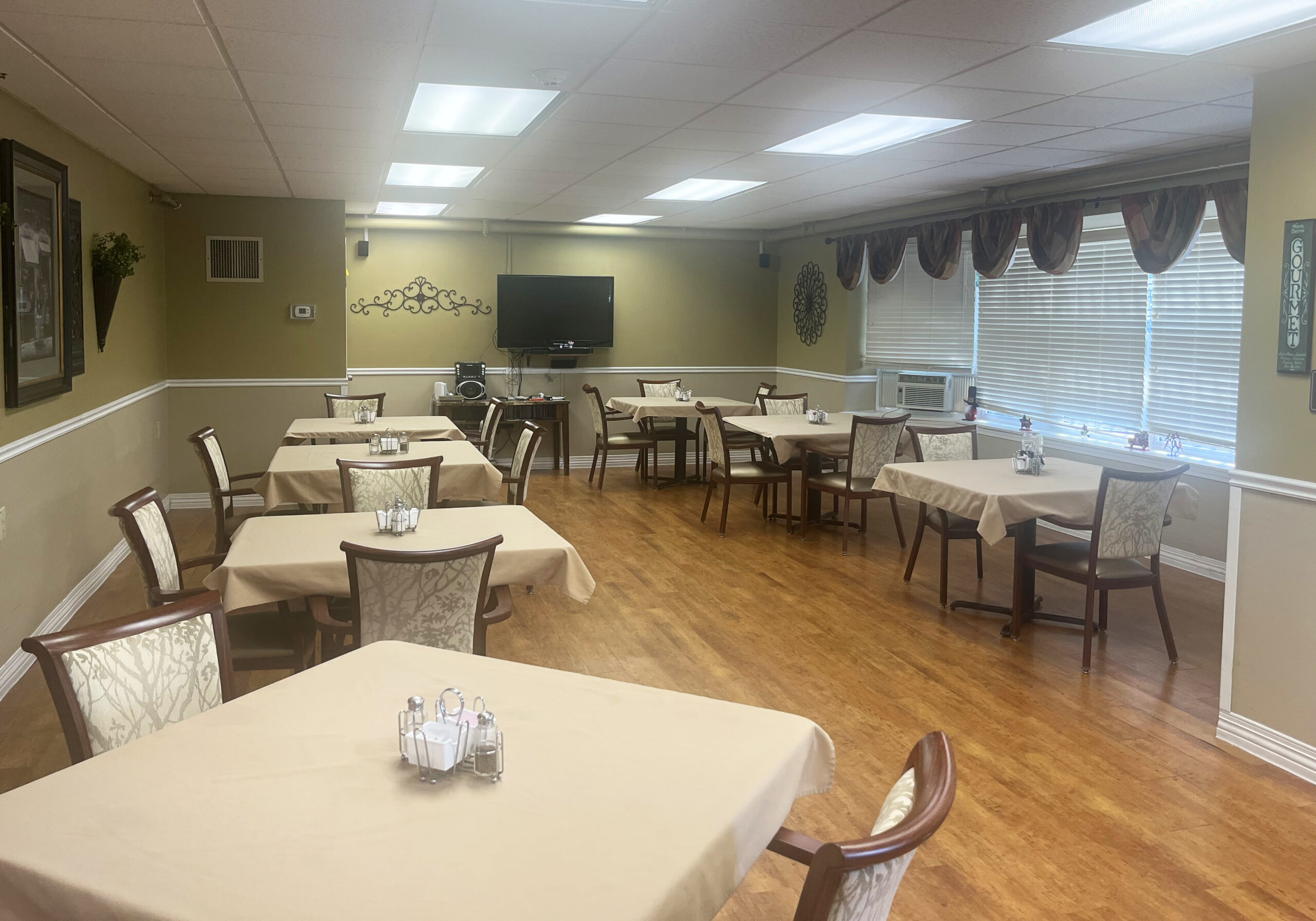 Dining area with tables and chairs in a communal setting.