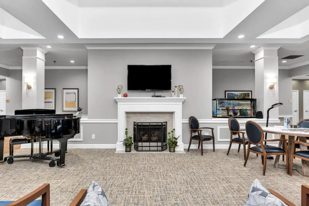Common area with seating, piano, and fireplace