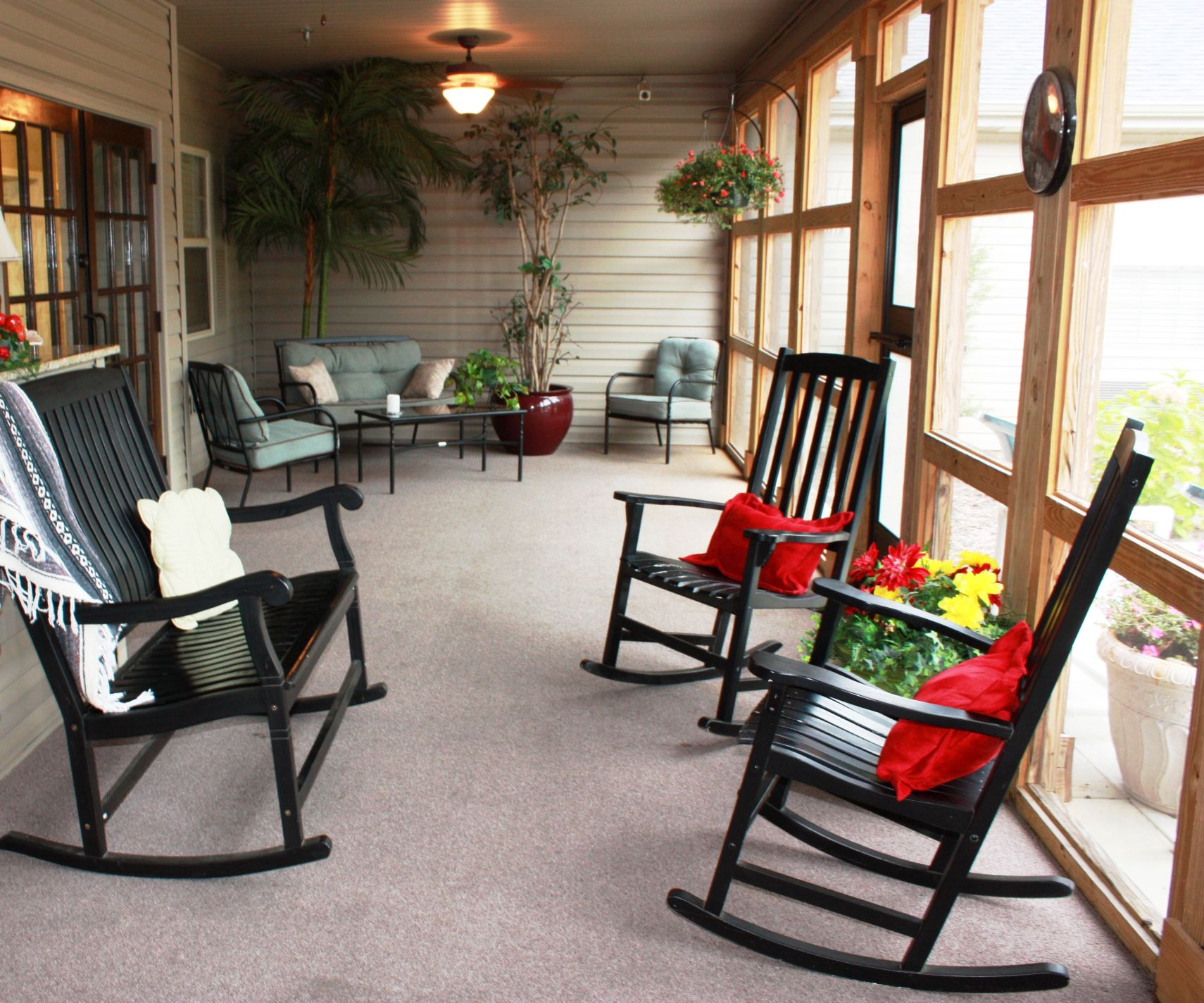 Inviting common area with rocking chairs and plants
