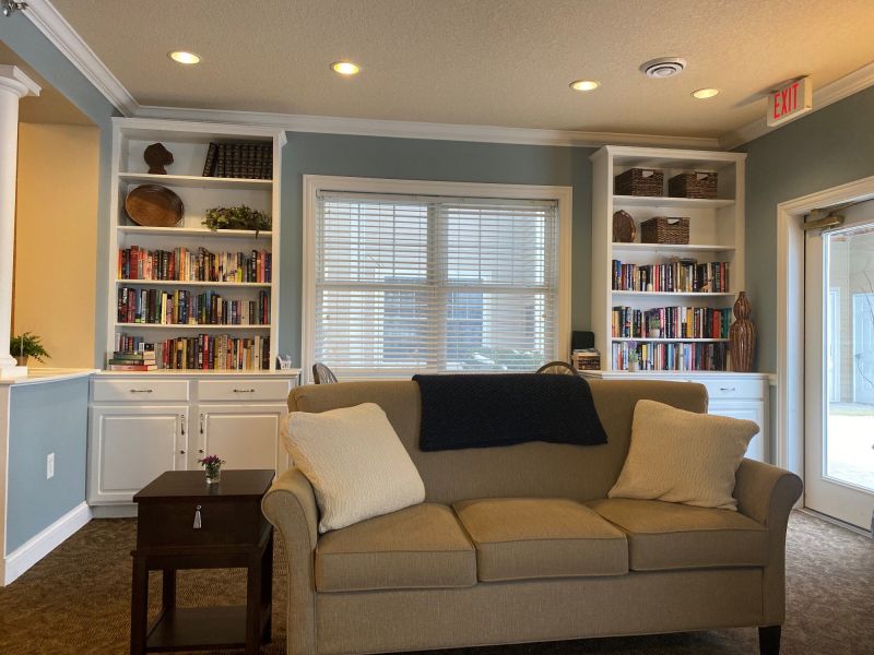 Cozy common area with a comfortable sofa and bookshelves