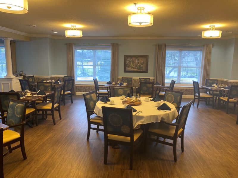 Interior dining room with tables and chairs set up for a meal