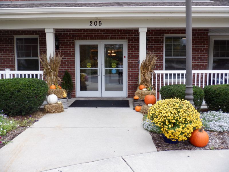 Exterior view of the facility entrance decorated for fall