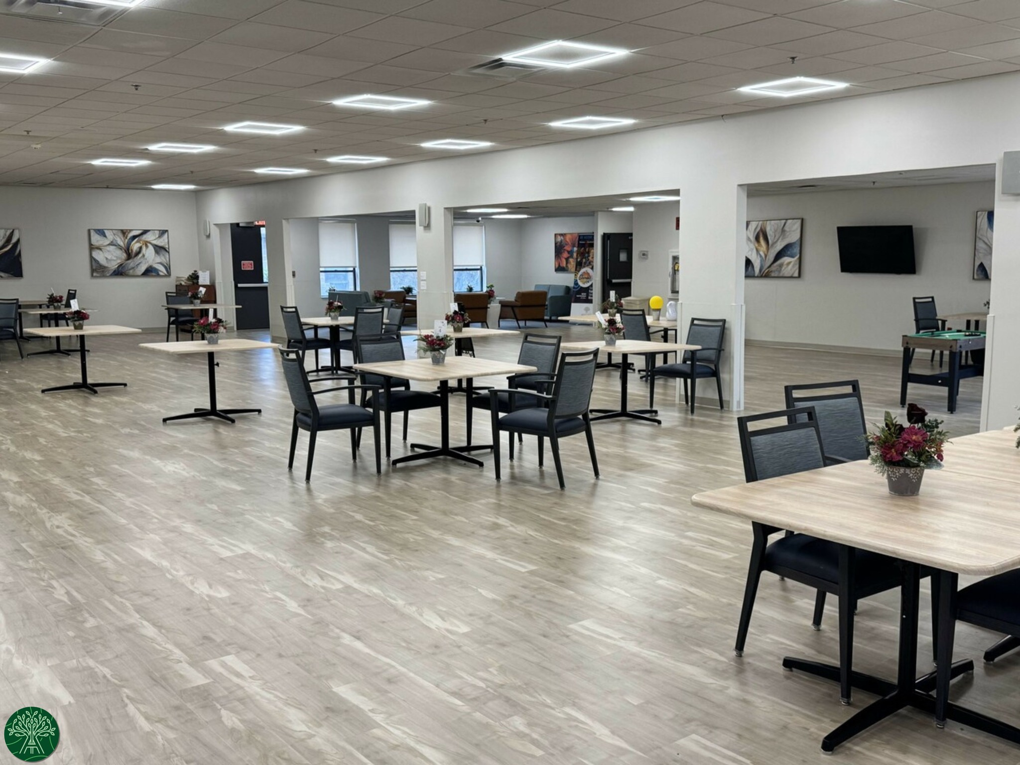 Bright and spacious common area with tables and chairs