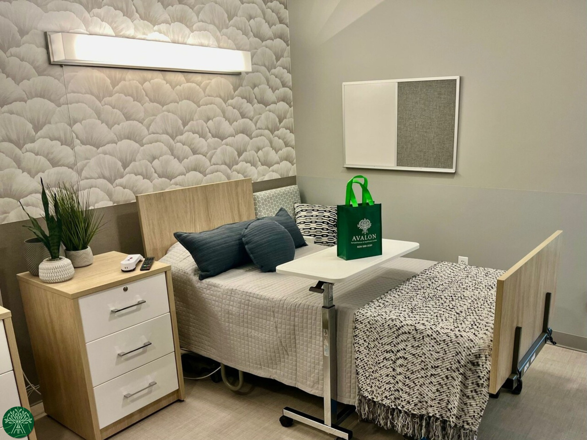 A well-decorated resident room with a bed and sitting area