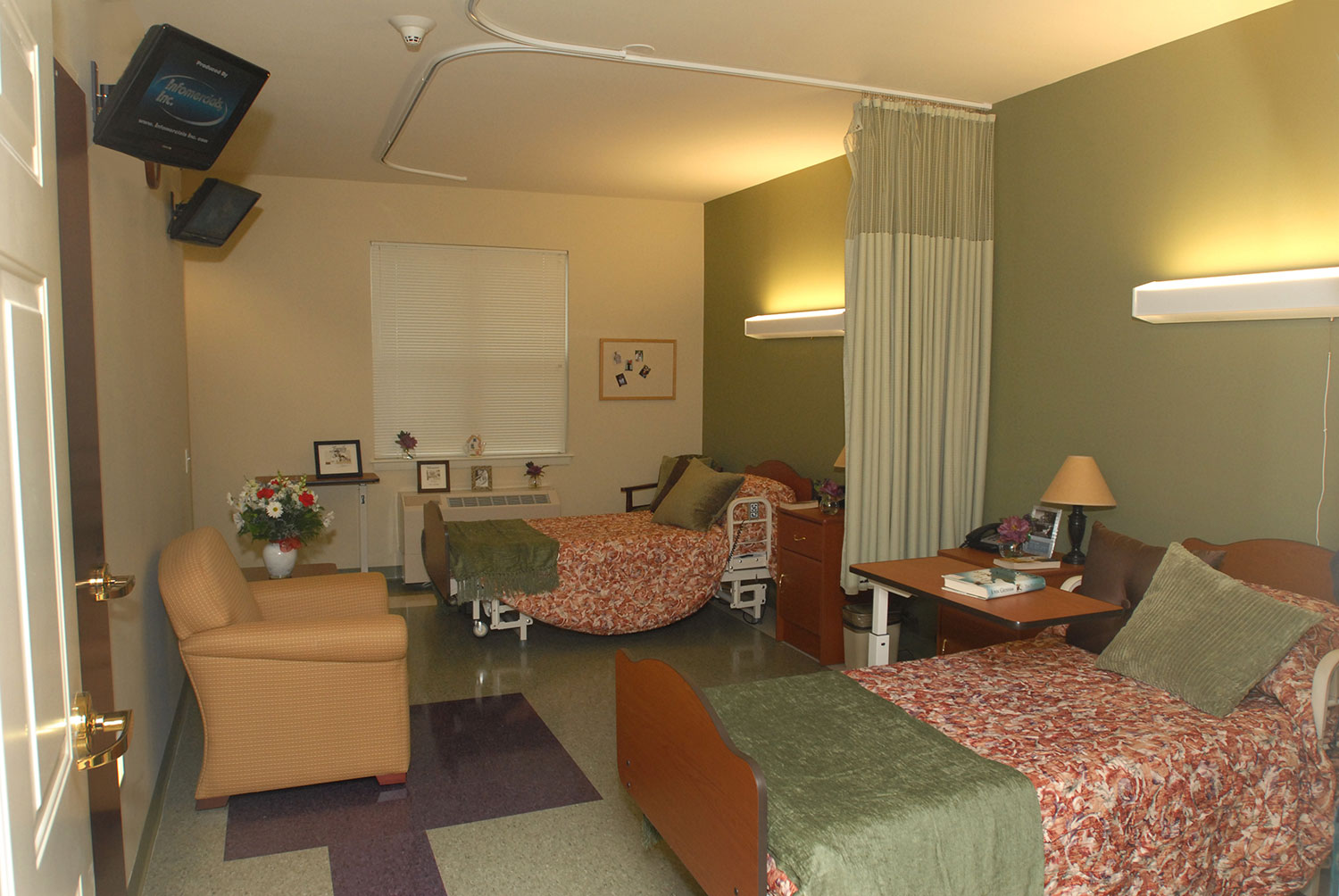Shared resident room with two beds and seating area