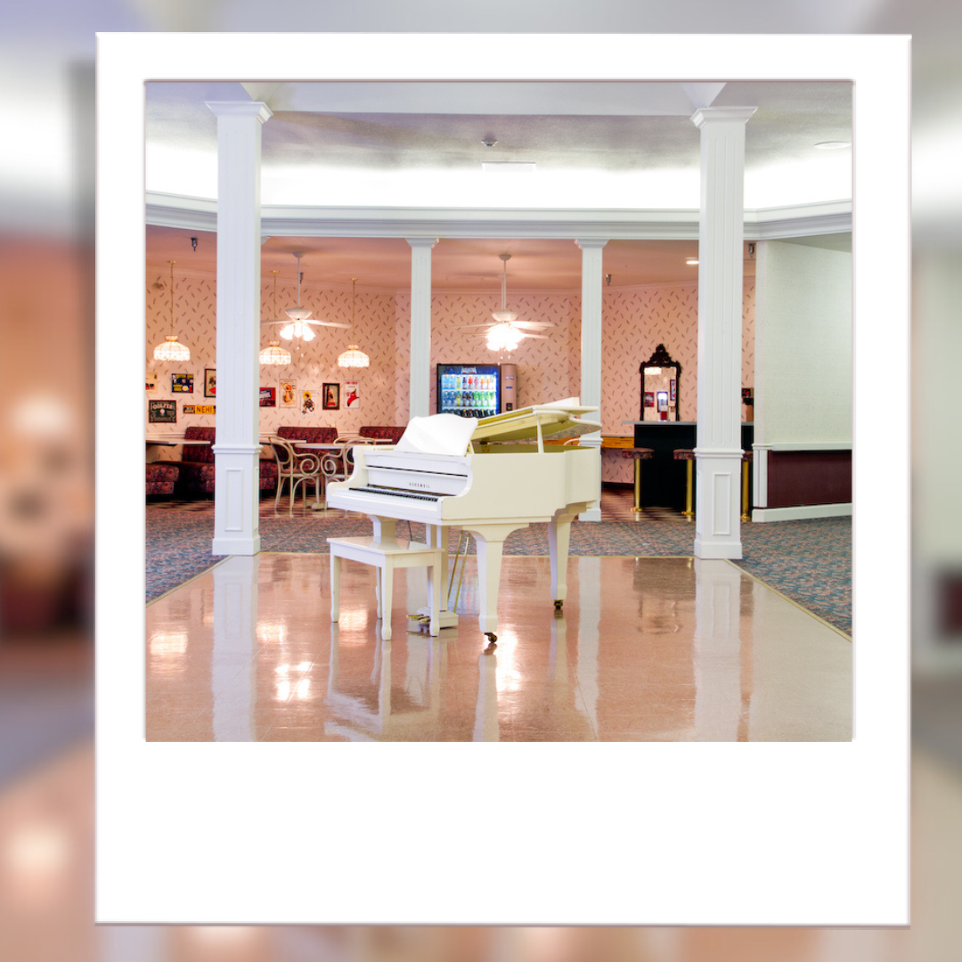 Interior view of a lobby with a grand piano.