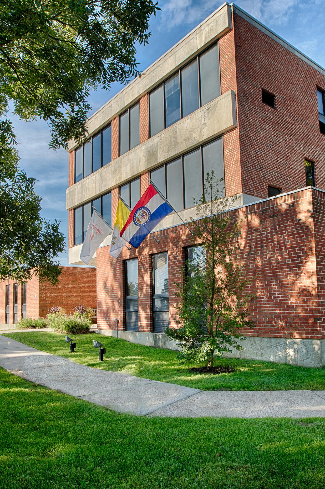 Exterior view of a senior health facility with flags