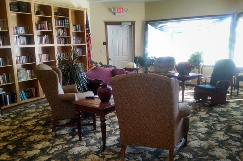 Cozy common area with seating and bookshelves