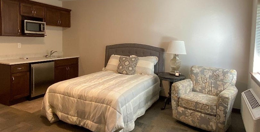 Cozy private room with a bed and chair