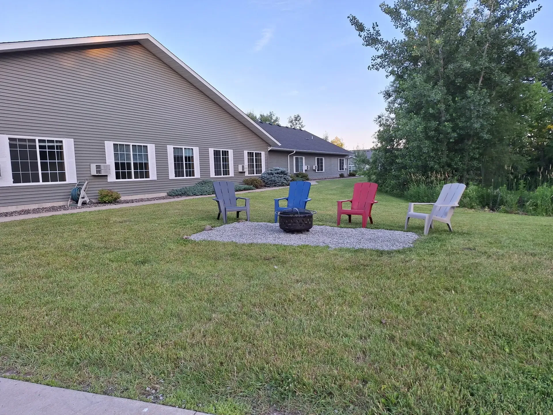Outdoor seating area with chairs and fire pit